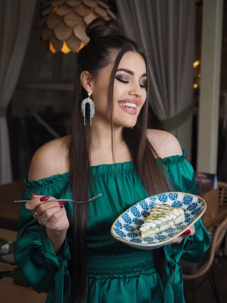  Brunette woman in evening dress eating a balanced meal, illustrating how to gain weight fast while maintaining a beautiful figure