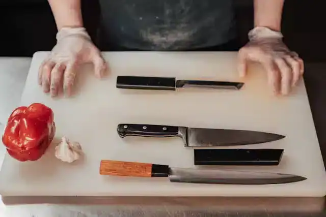  Sharp kitchen knives and fresh vegetables on a cutting board for fast meal prep